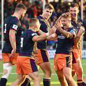 Edinburgh's Darcy Graham (centre) celebrates his second try in the win over Scarlets. (Photo by Paul Devlin / SNS Group)