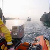 Alan Blair, ILB helm, guides the Kerry Girl yacht safely into Dunbar harbour (Photo: RNLI).