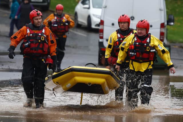 BRECHIN,SCOTLAND - OCTOBER 20: Members of a rescue team make their way through the flood waters on October 20, 2023 in Brechin Scotland. Areas close to the river have been overwhelmed by water which breached the flood defences in the early hours of this morning. Rare Red weather warnings are in place in Scotland and amber warnings in the north of England until Saturday as Storm Babet sweeps the country. (Photo by Jeff J Mitchell/Getty Images)