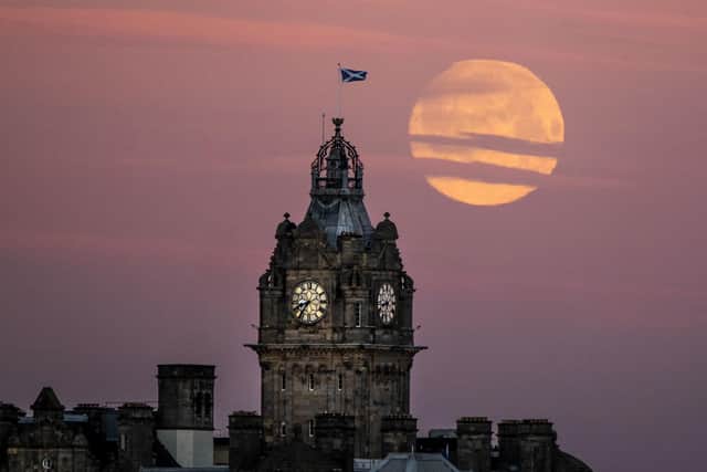 The moon sets behind the Balmoral Clock in Edinburgh. January's full moon was known the Wolf moon according to native north Americans. Photo: Jane Barlow/PA Wire