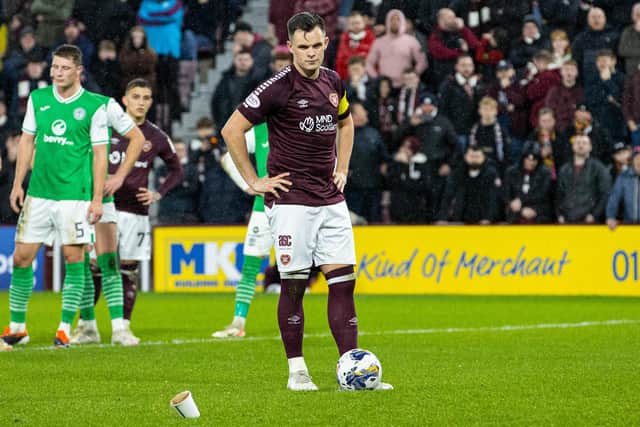 Lawrence Shankland inspects the objects thrown at him during Hearts v Hibs on Wednesday.