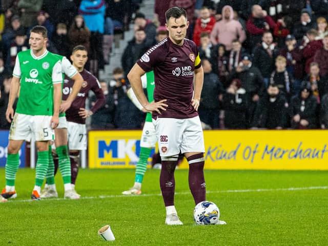 Lawrence Shankland inspects the objects thrown at him during Hearts v Hibs on Wednesday.