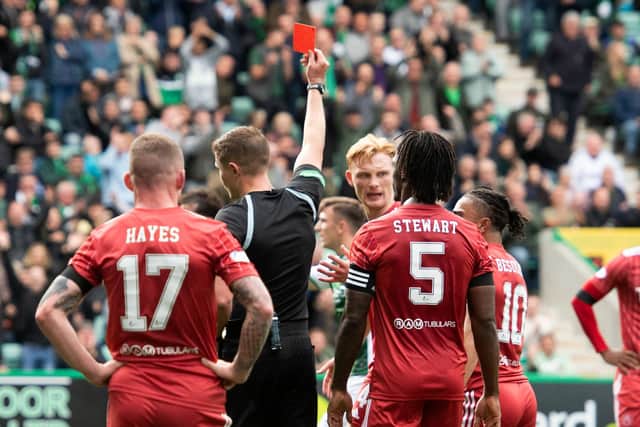 Referee David Dickinson shows Aberdeen defender Liam Scales a second yellow and red card for his foul on Ryan Porteous that led to Hibs' penalty. (Photo by Mark Scates / SNS Group)