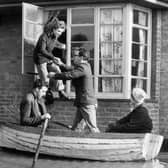 A family in Canvey Island, Essex, is evacuated from their home after the disastrous floods in 1953 (Picture: Topical Press Agency/Getty Images)