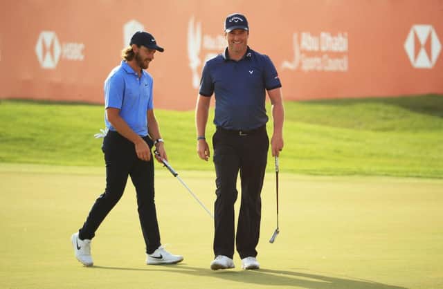 Marc Warren smiles after holing a birdie putt on the 18th green in the final round of the Abu Dhabi HSBC Championship. Picture: Andrew Redington/Getty Images.