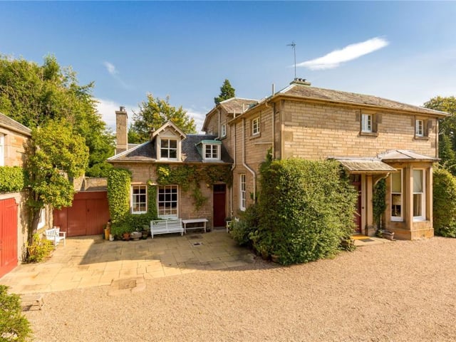 Side of house showing entrance to courtyard and single garage.