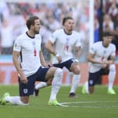 England's Harry Kane takes a knee in support of Black Lives Matter movement prior the Euro 2020 soccer semifinal match between England and Denmark