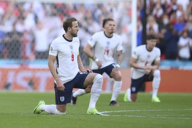 England's Harry Kane takes a knee in support of Black Lives Matter movement prior the Euro 2020 soccer semifinal match between England and Denmark