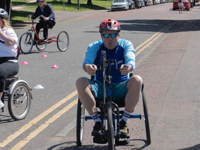 Rod Mitchell, Cycle Law Scotland Marketing Director, tries out a hand-powered bicycle.