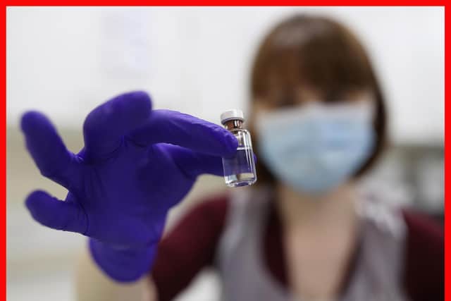 An NHS pharmacy technician at the Royal Free Hospital, London, simulates the preparation of the Pfizer vaccine to support staff training ahead of the rollout.