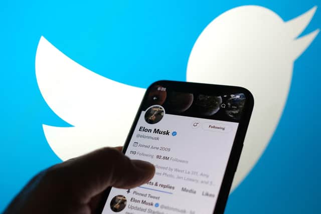 Elon Musk's Twitter account with a Twitter logo in the background  (Photo by Chris DELMAS / AFP) (Photo by CHRIS DELMAS/AFP via Getty Images)