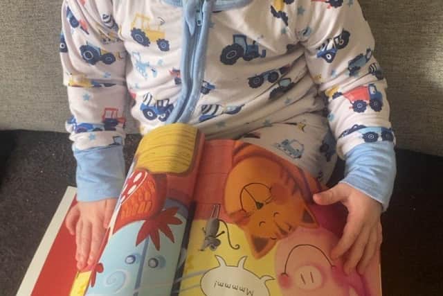 Two-year-old Alfie Smeaton loves his new book.
