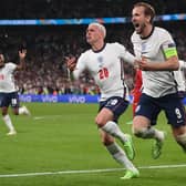 England's forward Harry Kane celebrates with Phil Foden after scoring the winning penalty against Denmark in the semi-final of Euro 2020. (Photo by LAURENCE GRIFFITHS/POOL/AFP via Getty Images)