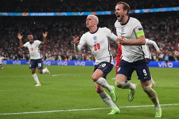 England's forward Harry Kane celebrates with Phil Foden after scoring the winning penalty against Denmark in the semi-final of Euro 2020. (Photo by LAURENCE GRIFFITHS/POOL/AFP via Getty Images)