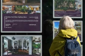 A person looking at advertisements in a estate agents' window. Picture: Yui Mok/PA Wire