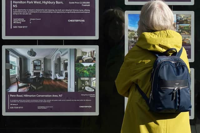 A person looking at advertisements in a estate agents' window. Picture: Yui Mok/PA Wire