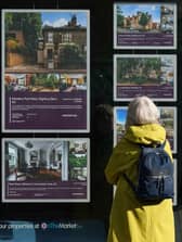 A person looking at advertisements in a estate agents' window. Picture: Yui Mok/PA Wire