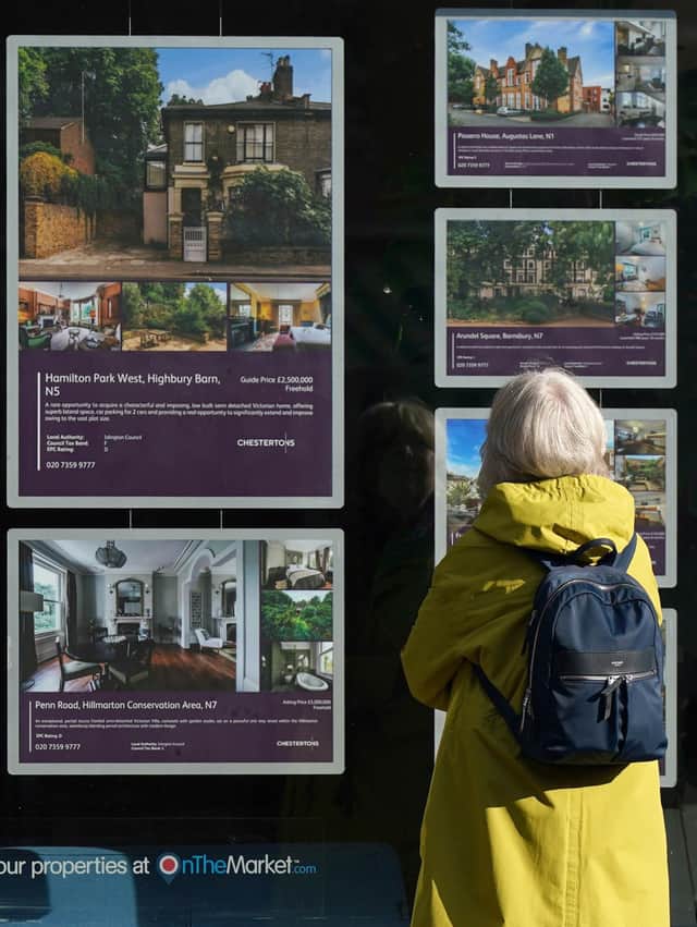 A person looking at advertisements in a estate agents' window. Picture: Yui Mok/PA Wire
