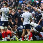 France's Thomas Ramos (R) celebrates as Scotland are not awarded a try.