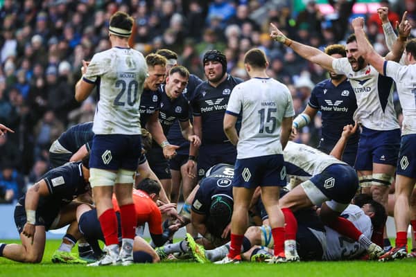 France's Thomas Ramos (R) celebrates as Scotland are not awarded a try.