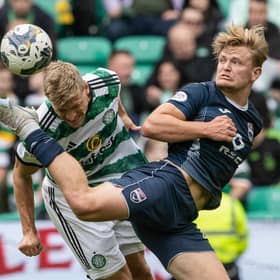 Celtic's Carl Starfelt battles with Ross County's Alex Samuel.