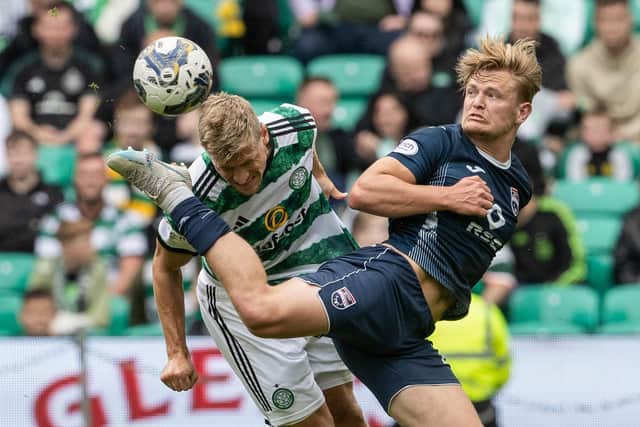 Celtic's Carl Starfelt battles with Ross County's Alex Samuel.