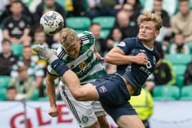 Celtic's Carl Starfelt battles with Ross County's Alex Samuel.