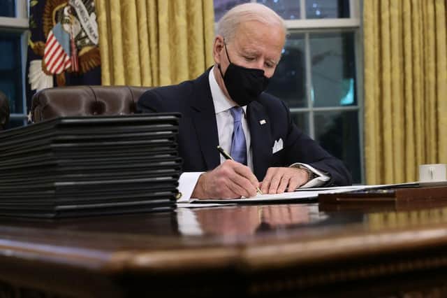 President Joe Biden prepares to sign a stack of executive orders in the Oval Office just hours after his inauguration on 20 January 2021 (Photo: Chip Somodevilla/Getty Images)