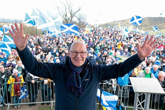 First Minister John Swinney poses on stage during the Believe In Scotland rally on March 28 2026 in Edinburgh (Picture: Jeff J Mitchell/Getty Images)
