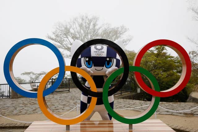 Tokyo 2020 Olympic Games mascot Miraitowa poses with the Olympic Symbol after unveiling ceremony on Mt. Takao to mark 100 days before the opening ceremony.
