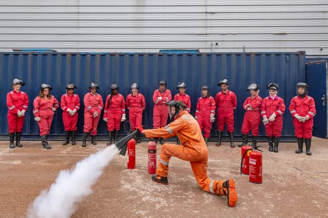 3t instructor showcasing BOSIET fire training using CO₂ extinguisher
