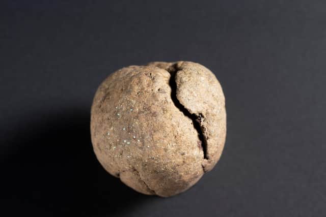 One of two mysterious dirt balls found in the bottom of the silver gilt vessel that hold a special secret. PIC: PA/NMS