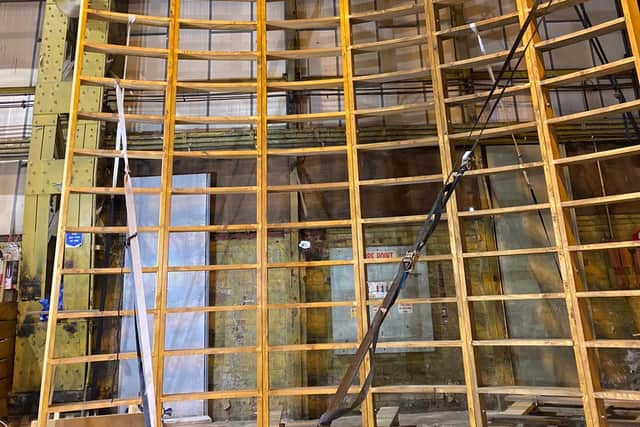 Taking shape: Artist Stephen Skrynka scales the wooden superstructure as it reaches a key point in its construction. Normally, the Wall of Death would be nailed together but his model, the first of its kind to be built in Scotland, has been made using joinery and hand tools.