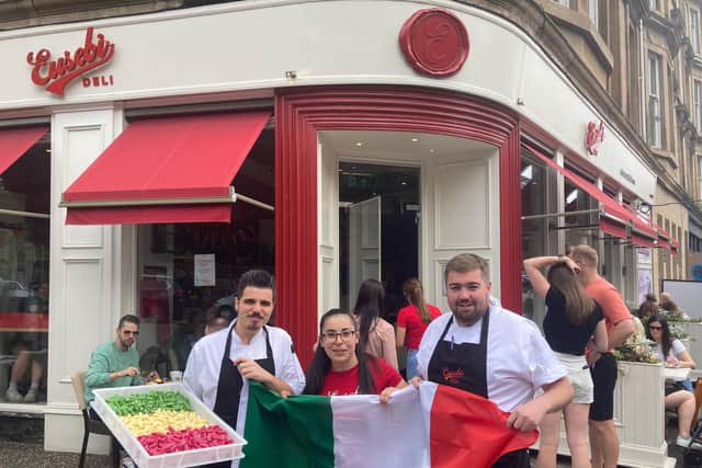 Scottish Italian staff from Eusebi Deli, Glasgow - Tano, Francesca and Robbie - hold up the Italian flag ans freshly made tri-coloured pasta ahead of the Euro 2020 game between Italy and England (Photo: Hannah Brown).