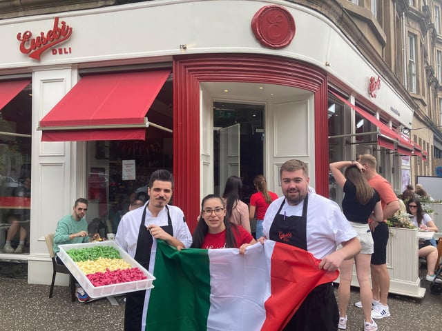 Scottish Italian staff from Eusebi Deli, Glasgow - Tano, Francesca and Robbie - hold up the Italian flag ans freshly made tri-coloured pasta ahead of the Euro 2020 game between Italy and England (Photo: Hannah Brown).
