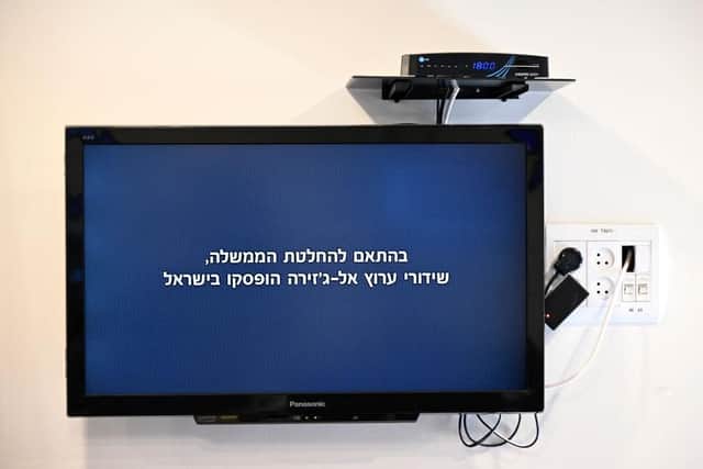 A picture taken on Sunday in Jerusalem, shows a message broadcasted on the Al Jazeera television network which reads "In accordance with the government decision, Al Jazeera channel broadcasts have been suspended in Israel".
