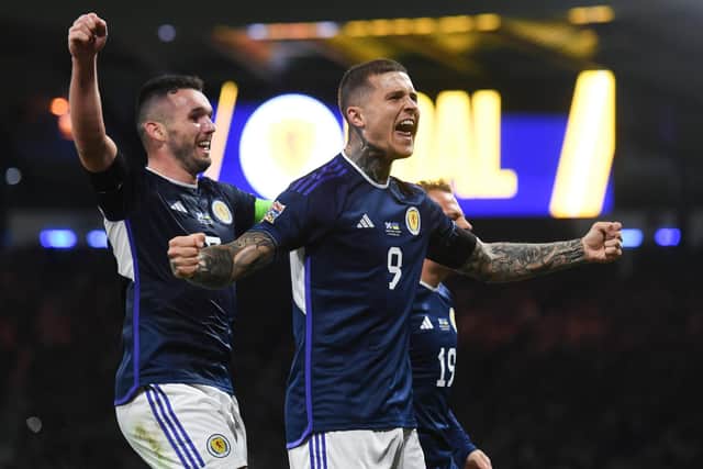 Lyndon Dykes celebrates netting Scotland's second goal in the 3-0 win over Ukraine with the scorer of the opener, John McGinn. (Photo by Craig Foy / SNS Group)