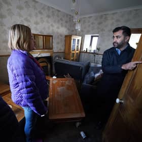 First Minister Humza Yousaf speaks to Paul Fowlie and partner Kim Clark as he looks at water damage in their house during a visit to Brechin. Photo: Andrew Milligan/PA Wire