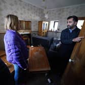 First Minister Humza Yousaf speaks to Paul Fowlie and partner Kim Clark as he looks at water damage in their house during a visit to Brechin. Photo: Andrew Milligan/PA Wire
