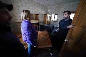 First Minister Humza Yousaf speaks to Paul Fowlie and partner Kim Clark as he looks at water damage in their house during a visit to Brechin. Photo: Andrew Milligan/PA Wire