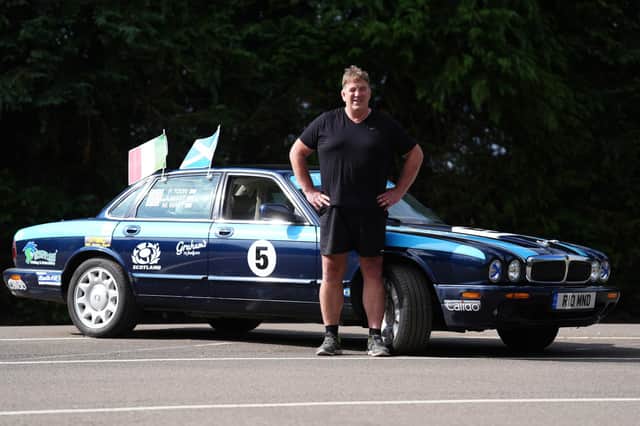 Alan Watt with the Jaguar car he is driving to Rome