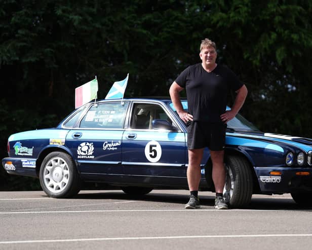 Alan Watt  with the Jaguar car he is driving to Rome