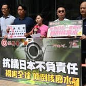 Members of the Hong Kong Federation of Trade Unions hold a protest outside the Japanese consulate in Hong Kong after Tokyo announced it was going ahead with releasing waste water from its Fukushima nuclear power plant. They are holding a banner which translates to "Protesting Japan's Irresponsibility in Endangering the Globe by releasing radioactive water".
