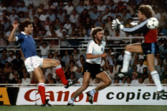 West Germany goalkeeper Harald Schumacher (r) jumps past the ball as he gets ready to collide with French defender Patrick Battiston during the World Cup semi-final in 1982. Photo: STAFF/AFP via Getty Images