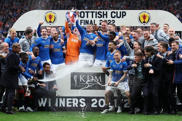 Rangers players and backroom staff celebrate with the Scottish Cup after beating Hearts 2-0 after extra time in the final at Hampden. (Photo by Ian MacNicol/Getty Images)