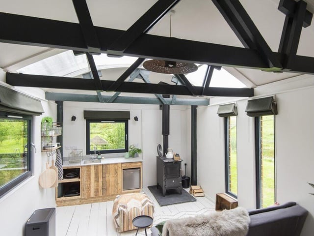 The stylish, modern-yet-rustic space not only floods with natural light, but showcases charming, natureful views from every window.