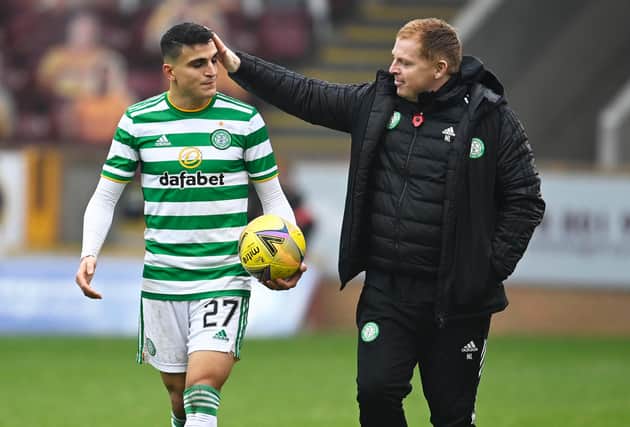 Mohamed Elyounoussi is congratulated by manager Neil Lennon after bagging a hat-trick against Motherwell. Picture: SNS
