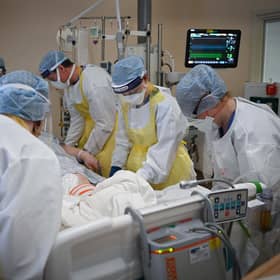 Staff at University Hospital Monklands attend to a Covid-positive patient on the ICU ward on February 5, 2021 in Airdrie, Scotland. Photo by Jeff J Mitchell/Getty Images