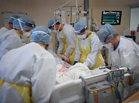 Staff at University Hospital Monklands attend to a Covid-positive patient on the ICU ward on February 5, 2021 in Airdrie, Scotland. Photo by Jeff J Mitchell/Getty Images