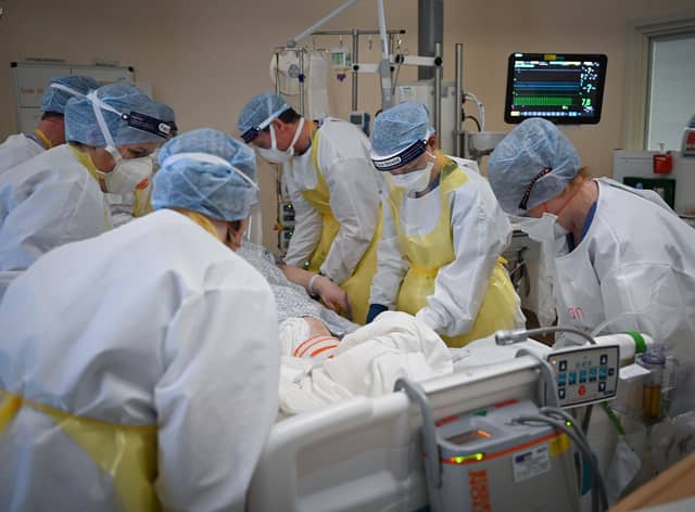 Staff at University Hospital Monklands attend to a Covid-positive patient on the ICU ward on February 5, 2021 in Airdrie, Scotland. Photo by Jeff J Mitchell/Getty Images